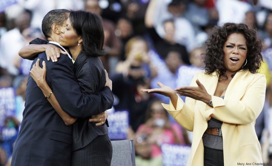 Democratic presidential hopeful, Sen.Barack Obama, D-Ill., and his wife Michelle embrace as Oprah Winfrey campaigns with them Sunday, Dec. 9, 2008, during a rally at Williams Brice Stadium in Columbia, S.C. (AP Photo/Mary Ann Chastain)