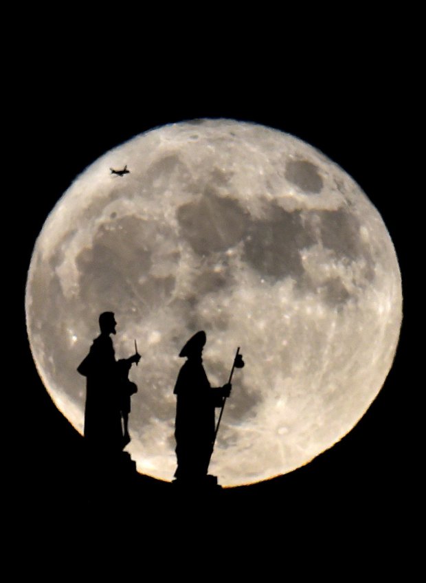 Statues on the Almudena cathedral and a plane are silhouetted against a Supermoon in Madrid on November 14, 2016. The phenomenon happens when the moon is full at the same time as, or very near, perigee -- its closest point to Earth on an elliptical, monthly orbit. It was the closest to Earth since 1948 at a distance of 356,509 kilometres (221,524 miles), creating what NASA described as "an extra-supermoon". / AFP PHOTO / GERARD JULIENGERARD JULIEN/AFP/Getty Images