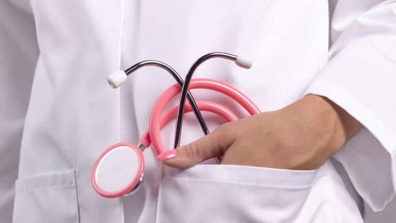 Feminine doctor with pink stethoscope in pocket