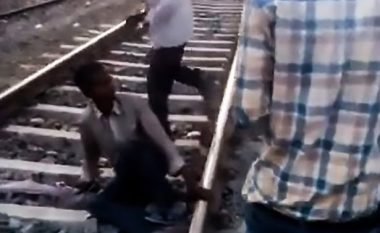 Qëndron i shtrirë në binarë, treni me dhjetëra vagonë kalojnë mbi të – burri shpëton pa asnjë lëndim (Video)