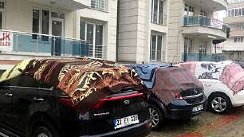 Parashikohet breshër i rrëmbyeshëm, turqit mbulojnë veturat me tepihë dhe batanije (Foto)