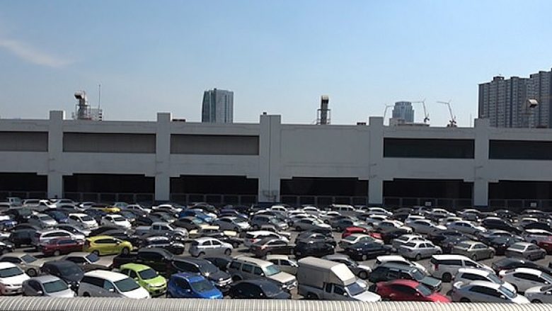 Për të shmangur pagesën në vende tjera, qindra mijëra shoferë në Bangkok parkojnë veturat pak centimetra larg njëra-tjetrës në një parking pa pagesë (Video)