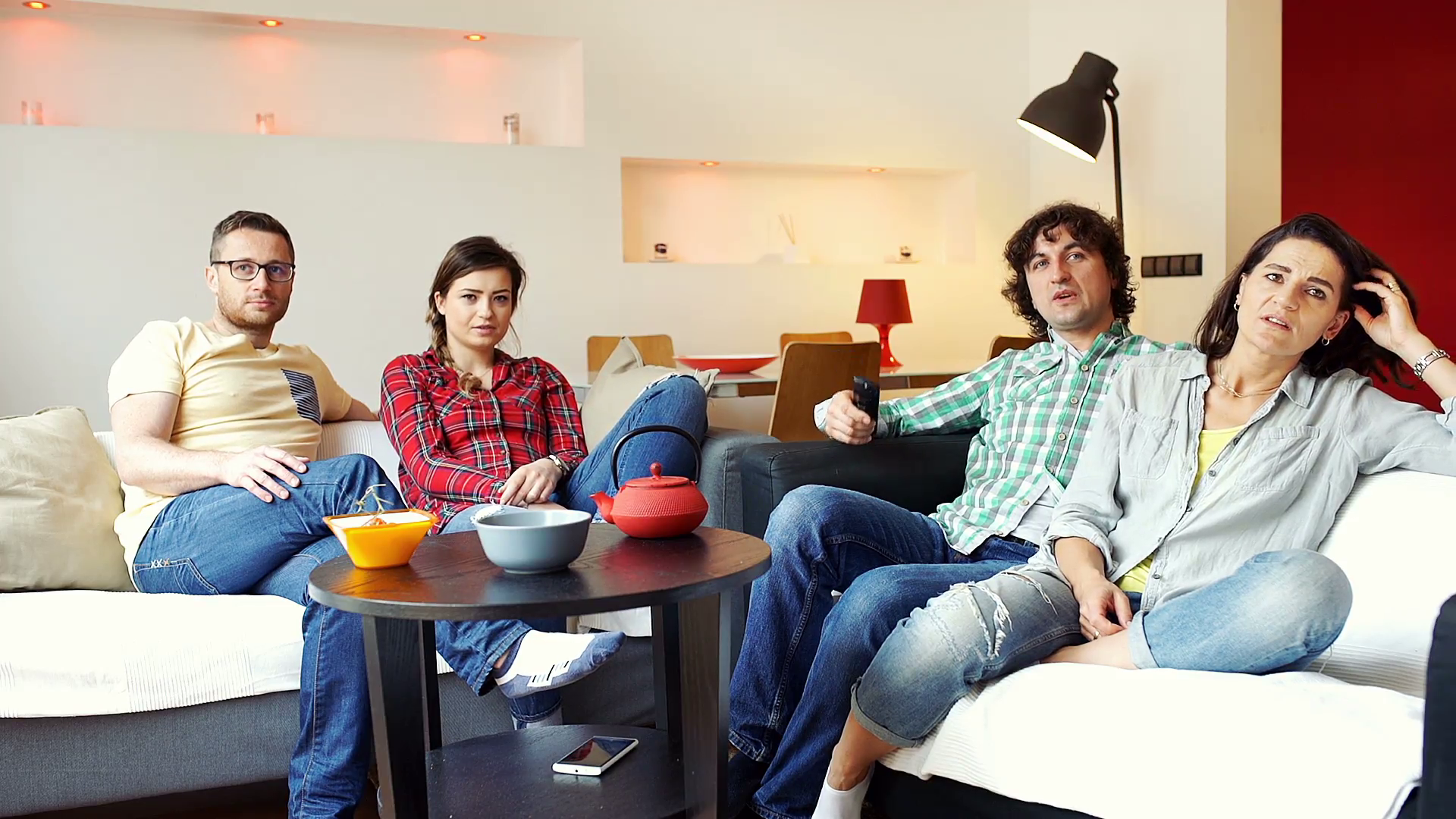 Simple Family. Family watching TV. Female friends watching TV together. Unhappy guy watching TV.