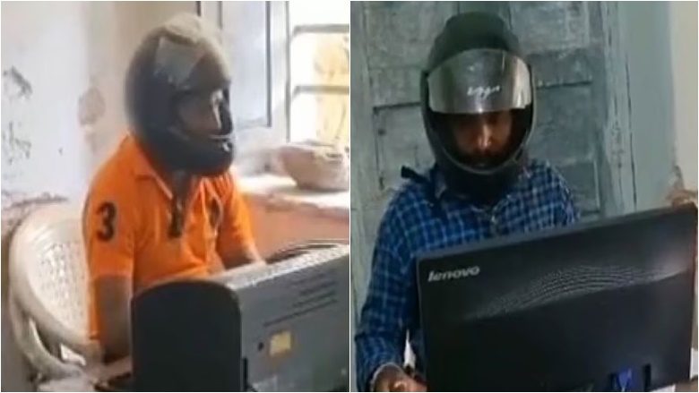 Punëtorët e një zyre qeveritare në Indi përdorin helmeta për t’u mbrojtur nga copëzat e tavanit të cilat bien mbi kokat e tyre