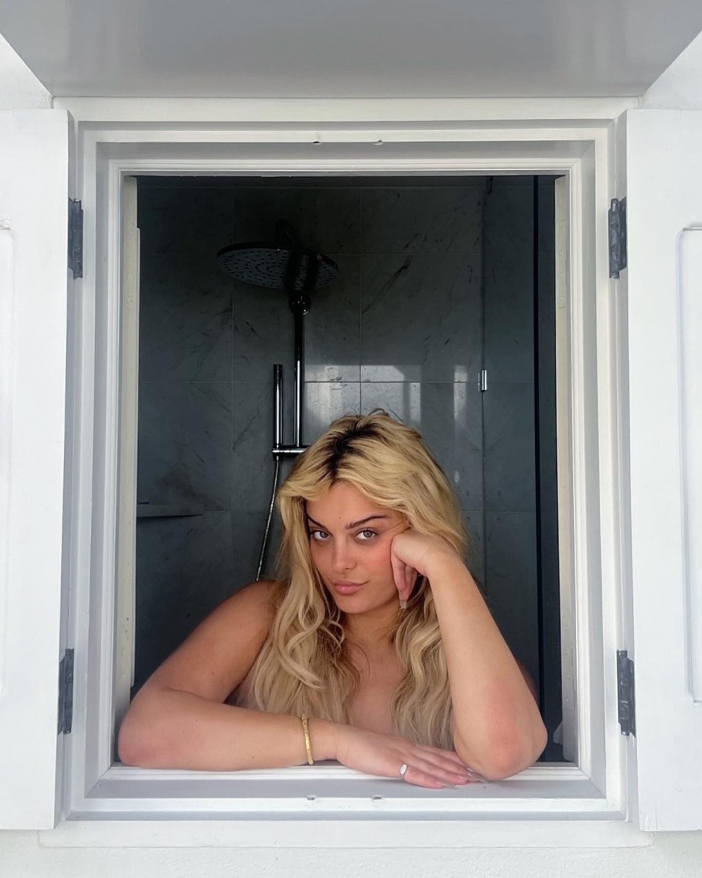Bebe Rexha poses completely naked from the shower during the holidays